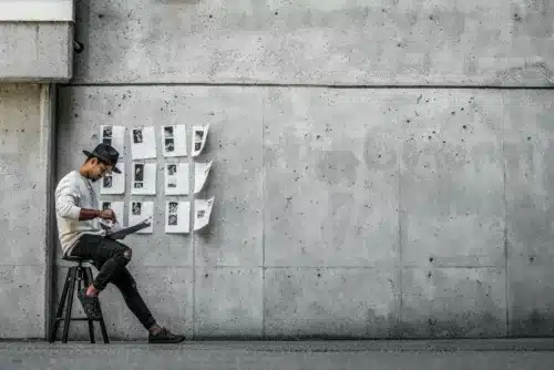 Man sitting in front of a wall